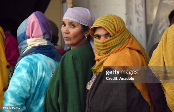 Women voters in queue to cast their votes during the eight phase of District Development Council elections, in Pattan area of Baramulla, on December...