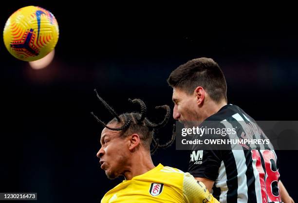 Fulham's Jamaican striker Bobby Decordova-Reid and Newcastle United's Argentinian defender Federico Fernandez jump for the ball during the English...