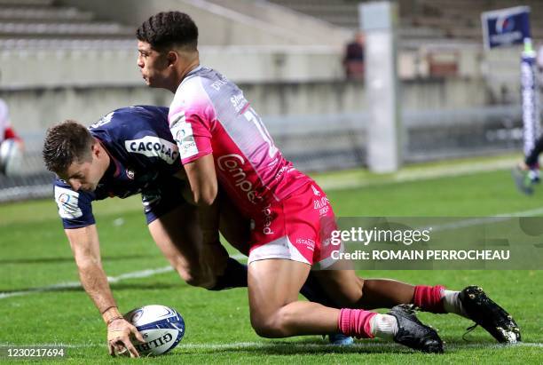 Bordeaux' Argentinian wing Santiago Cordero dives across the line to score a try during the European Rugby Champions Cup rugby union match between...