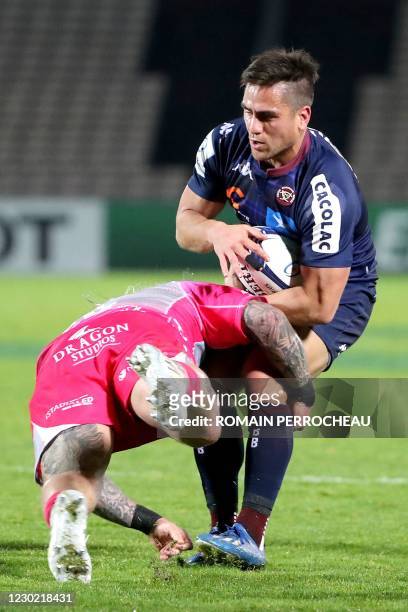 Bordeaux' French fly half Ben Botica is is tackled during the European Rugby Champions Cup rugby union match between Union Bordeaux Begles and...