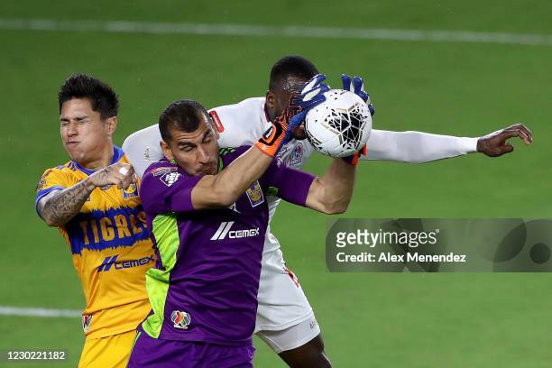 Nahuel Guzman of Tigres UANL makes a save in front of Carlos Salcedo of Tigres UANL and Yustin Arboleda of CD Olimpia during the CONCACAF Champions...