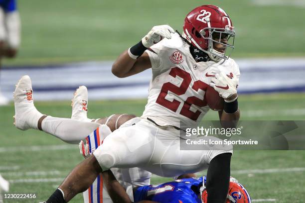 Running back Najee Harris of the Alabama Crimson Tide is tackled during the SEC Championship football game between the Florida Gators and the Alabama...
