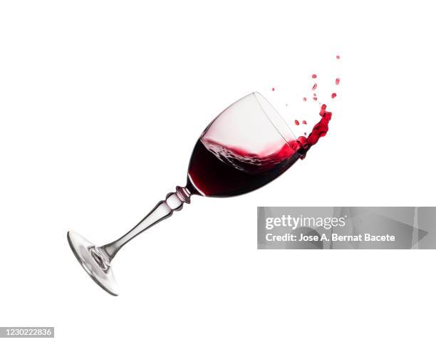 red wine splashing in glass in front of white background - broken cup stock-fotos und bilder