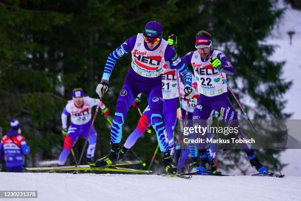 Ilkka Herola of Finnland and Alessandro Pittin of Italia competes during the Men's Gundersen Normal Hill HS98/10.0 Km at the FIS Nordic Combined...