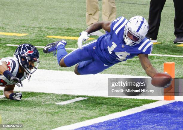 Zach Pascal of the Indianapolis Colts stretches for the game winning touchdown in as Vernon Hargreaves III of the Houston Texans falls short during...