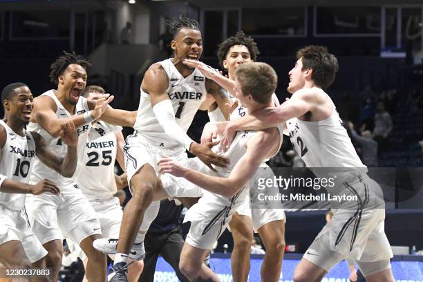 Adam Kunkel of the Xavier Musketeers celebrates hitting the winning in the second half with Paul Scruggs a college basketball game against the...