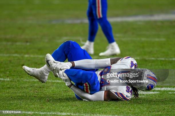 Buffalo Bills defensive tackle Vernon Butler grabs his leg after an apparent injury during a game between the Denver Broncos and the Buffalo Bills at...