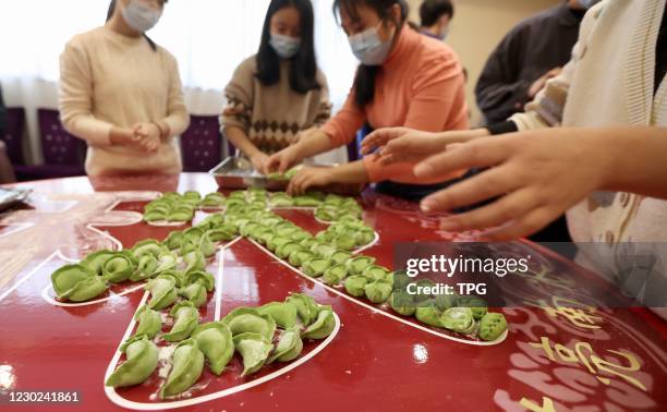 The college students are making dumplings to welcome the winter solstice festival on 20th December, 2020 in Nanjing,Jiangsu,China