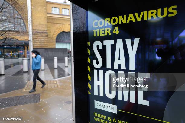 Coronavirus Tier 4 Stay Home poster near King's Cross railway station in London, U.K., on Monday, Dec. 21, 2020. More than 16 million Britons are now...