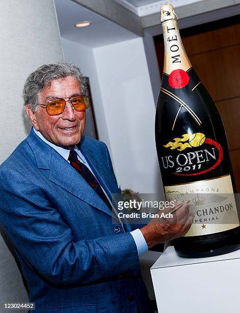 Singer Tony Bennett signs a 200 lb Nebuchadnezzar bottle of Moet & Chandon presented to him for his 85th birthday at the US Open's USTA Serves Gala,...