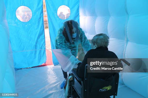 Woman meets her mother in the Room of Hugs, a structure to allow relatives of a retirement home for the elderly, to meet their loved ones safely from...