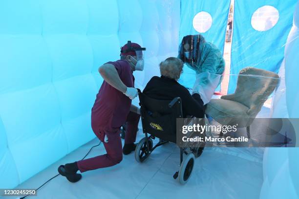 Woman meets her mother in the Room of Hugs, a structure to allow relatives of a retirement home for the elderly, to meet their loved ones safely from...