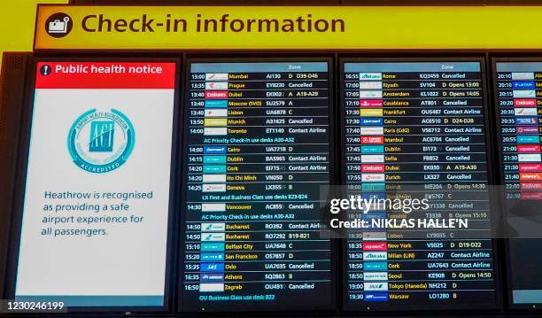 An electronic information display board shows the "cancelled" status of flights, including those bound for Dublin, Istanbul, and Munich among others,...