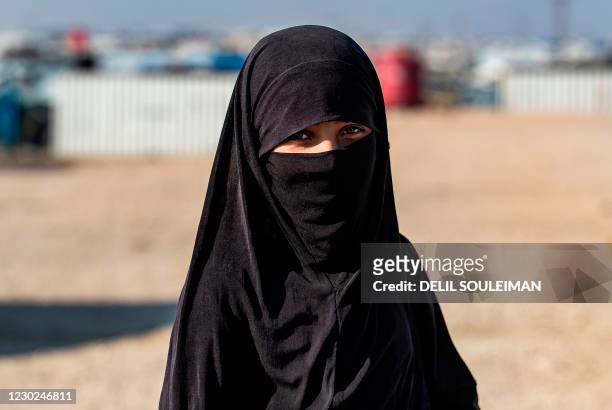 Syrian woman, suspected of being related to Islamic State group fighters, gathers at the Kurdish-run al-Hol camp, before being released to return to...