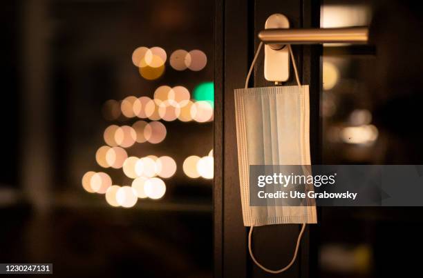 Bonn, Germany In this photo illustration a mask is hanging on a door handle on December 17, 2020 in Bonn, Germany.