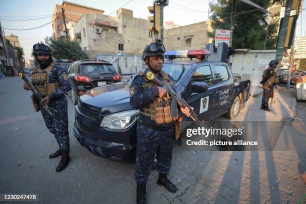 December 2020, Iraq, Baghdad: Iraqi police forces are deployed near the US Embassy in Baghdad, a day after several rockets were fired into Baghdad's...