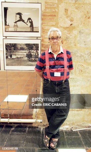 Press photographer Elliott Erwitt poses in front of some pictures of his exhibition presented at the "Eglise des Dominicains" during the 18th...