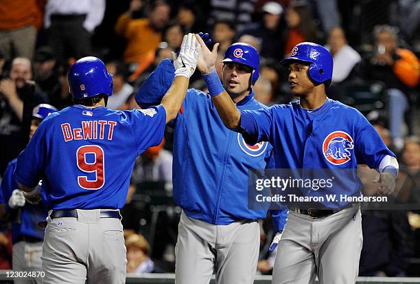 Blake DeWitt of the Chicago Cubs is greeted at home plate by Randy Wells and Starlin Castro after hitting a three-run home run against the San...