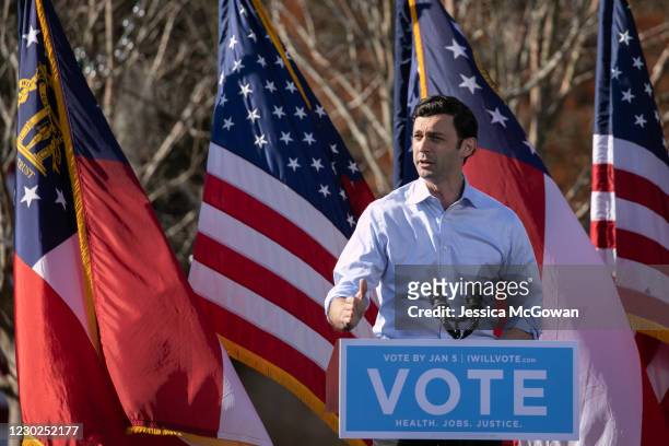 Georgia Democratic Senate candidate Jon Ossoff addresses the crowd during a drive-in rally at Bibb Mill Event Center on December 21, 2020 in...