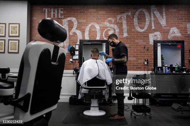 Anthony Maiuri has his haircut by barber John Mellino at the Boston Barber Exchange on Water Street in Boston, MA on October 21, 2020. The pandemic...
