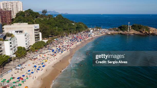 An aerial view of people enjoying the weather at Arpoador beach on December 20, 2020 in Rio de Janeiro, Brazil. According to the State Secretary of...