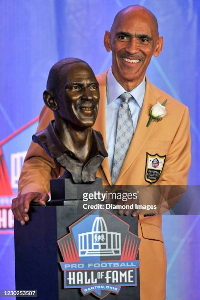 Former NFL defensive back and head coach Tony Dungy poses with his bronze bust after his induction into the Pro Football Hall of Fame during the Pro...