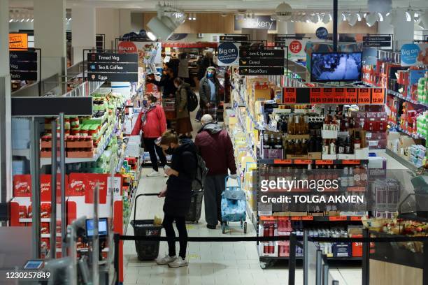 Shoppers browse for goods inside an Lidl supermarket in Walthamstow in north east London on December 22, 2020. - The British government said Tuesday...