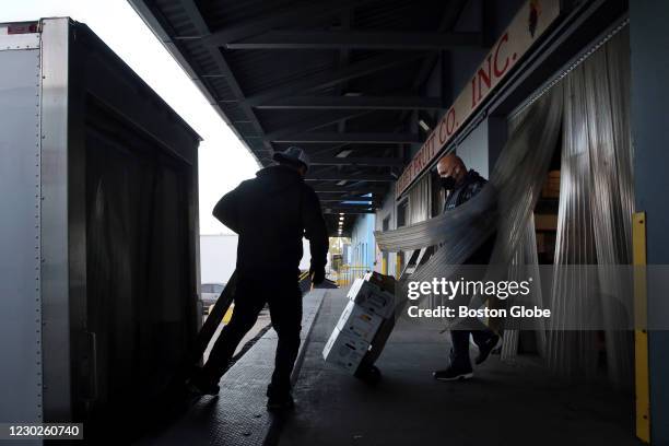Owner John Rossetti , right, and Alvaro Teos load produce orders onto a truck at Fleet Fruit Company in Chelsea, MA on October 20, 2020. The pandemic...