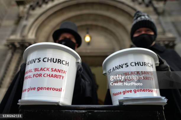 St Ann's vicar, Canon David Gillespie and and caretaker Fred Deane holding collection buckets seen outside the church during the annual seven-day...