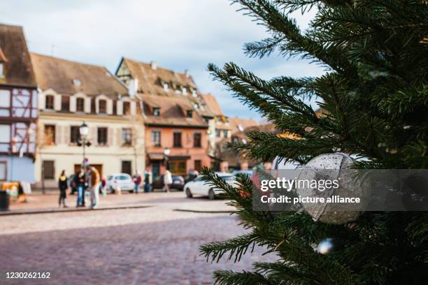 December 2020, France, Colmar: Christmas decorations hang on a Christmas tree in the old town of Colmar. In the past few days, many Germans drove...