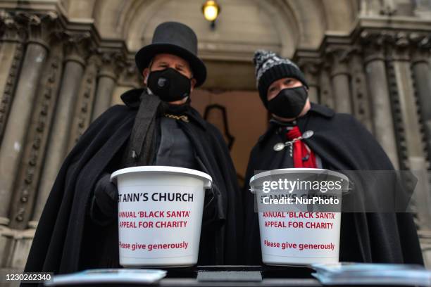 St Ann's vicar, Canon David Gillespie and and caretaker Fred Deane holding collection buckets seen outside the church during the annual seven-day...