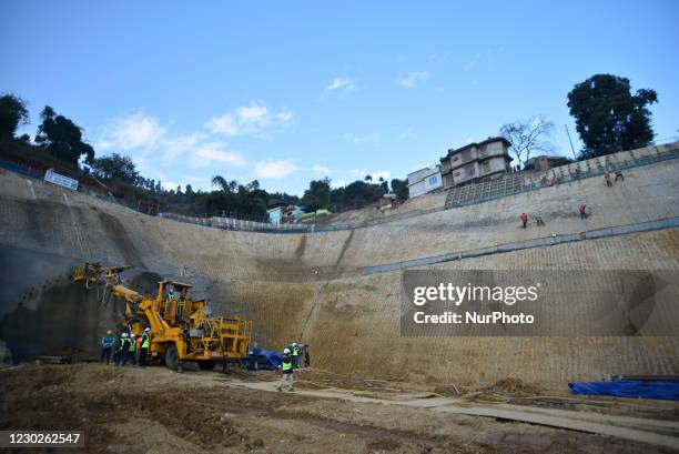 Nepalese workers gestures at the excavation site of Nepal's first road Sisnekhola-Dahchok tunnel project at Nagdhunga, Kathmandu, Nepal on Tuesday,...