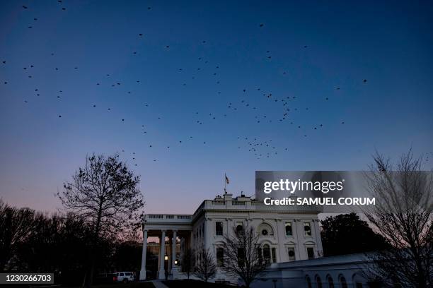 The White House is seen as the sun sets in Washington, DC on December 22, 2020. - A new coronavirus relief bill was approved in both Houses of...