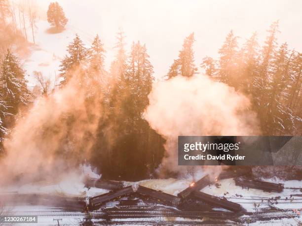 In this aerial view from a drone, smoke and steam rise from burning, derailed train carrying crude oil on December 22, 2020 in Custer, Washington....