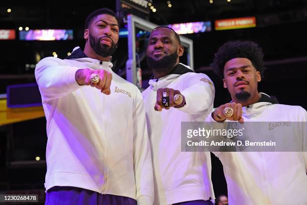 Anthony Davis, LeBron James and Quinn Cook of the Los Angeles Lakers pose for a photo as they get their 2019-20 NBA Championship ring during the ring...