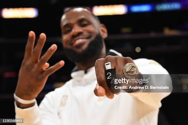 LeBron James of the Los Angeles Lakers poses for a photo as he gets his 2019-20 NBA Championship ring during the ring ceremony before the game...