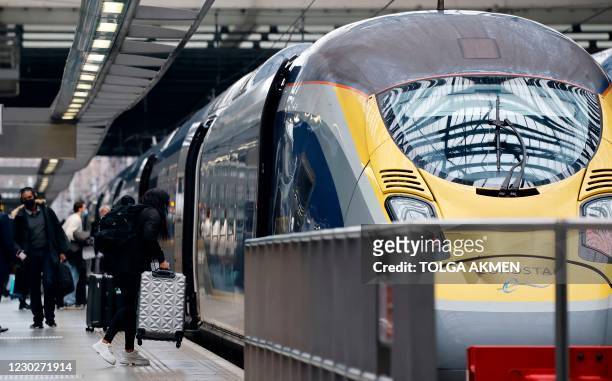 Passengers board a Eurostar train at St Pancras International station in London on December 23 as services prepare to resume following a 48 hour...