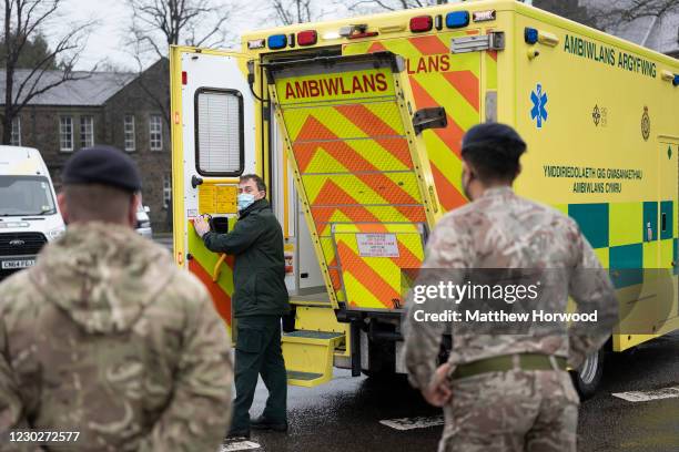 Members of the military practice loading and unloading a stretcher into an ambulance at Maindy Barracks on December 23, 2020 in Cardiff, Wales. The...