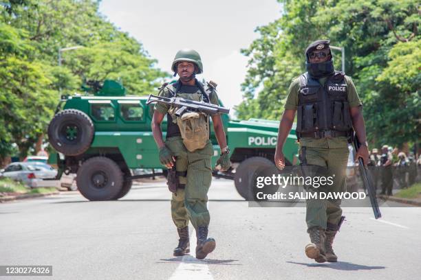 Police officers patrol the streets as supporters of the opposition United Party for National Development leader Hakainde Hichilema march in the...