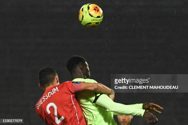 Nimes French defender Kelyan Guessoum fights for the ball with Dijon's Bissau-Guinean forward Mama Balde during the French L1 football match between...
