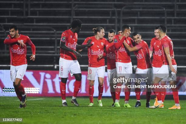 Nimes' Macedonian forward Matteo Ahlinvi celebrates with teammates after scoring a goal during the French L1 football match between Nimes Olympique...