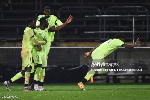 Dijon's players celebrate after scoring a goal during the French L1 football match between Nimes Olympique and Dijon FCO at the Costieres stadium in...