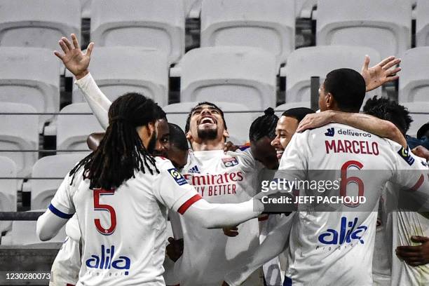 Lyon's Brazilian midfielder Lucas Paqueta celebrates with his teammates after scoring a goal during the French L1 football match between Lyon and FC...