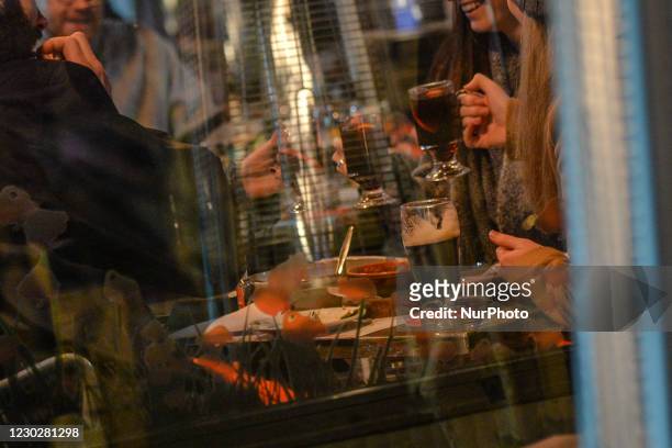 People enjoy a drink on a bar-restaurant terasse in Dublin's city center. On Wednesday, December 23 in Dublin, Ireland.
