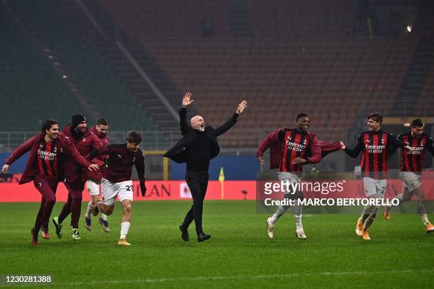 Milan's Italian coach Stefano Pioli celebrates with AC Milan's Portuguese forward Rafael Leao , AC Milan's Italian forward Daniel Maldini and AC...