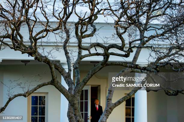 President Donald Trump emerges from the Oval Office as he departs the White House en route to Mar-a-Lago, the President's private club, where they...
