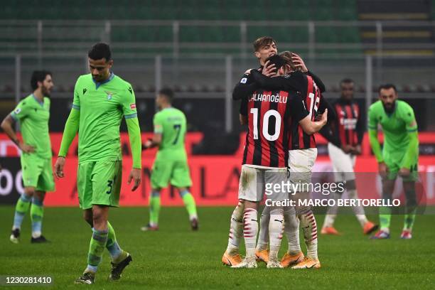 Milan's Turkish midfielder Hakan Calhanoglu , AC Milan's Italian forward Daniel Maldini and AC Milan's Norwegian forward Jens Petter Hauge embrace at...