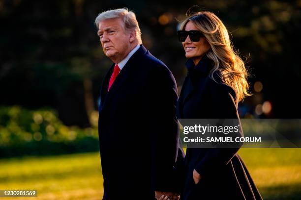 President Donald Trump and First Lady Melania Trump walk towards Marine One as they depart the White House en route to Mar-a-Lago, the President's...