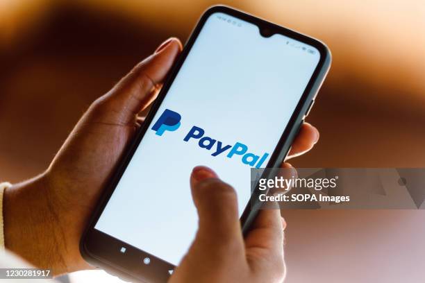 In this photo illustration the PayPal logo seen displayed on a smartphone.