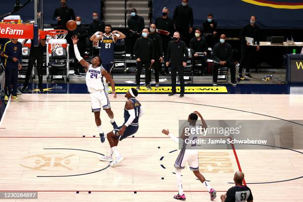 Buddy Hield of the Sacramento Kings tips in the game-winning shot against the Denver Nuggets at Ball Arena on December 23, 2020 in Denver, Colorado....